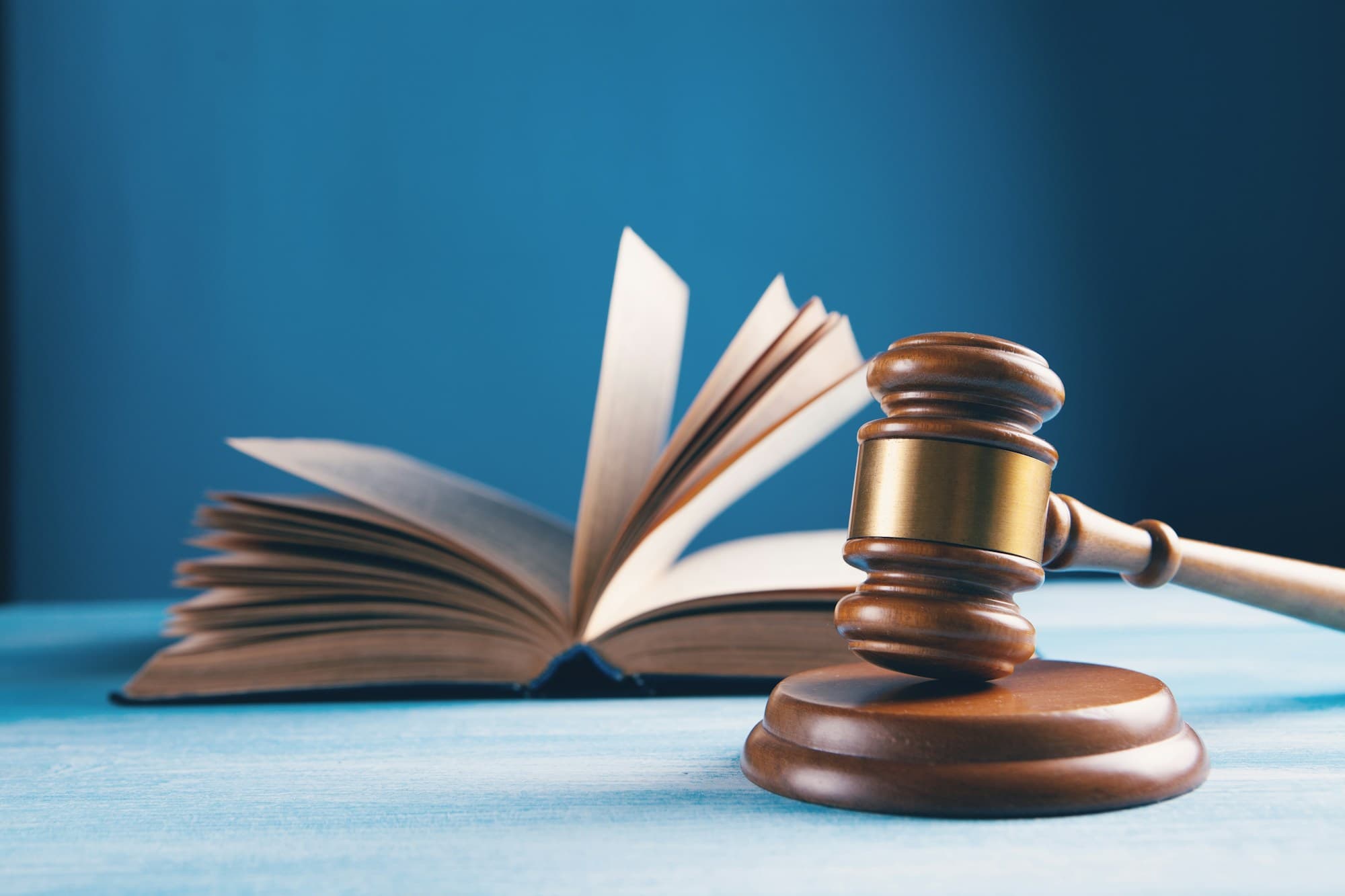 A judge’s gavel beside an open law book